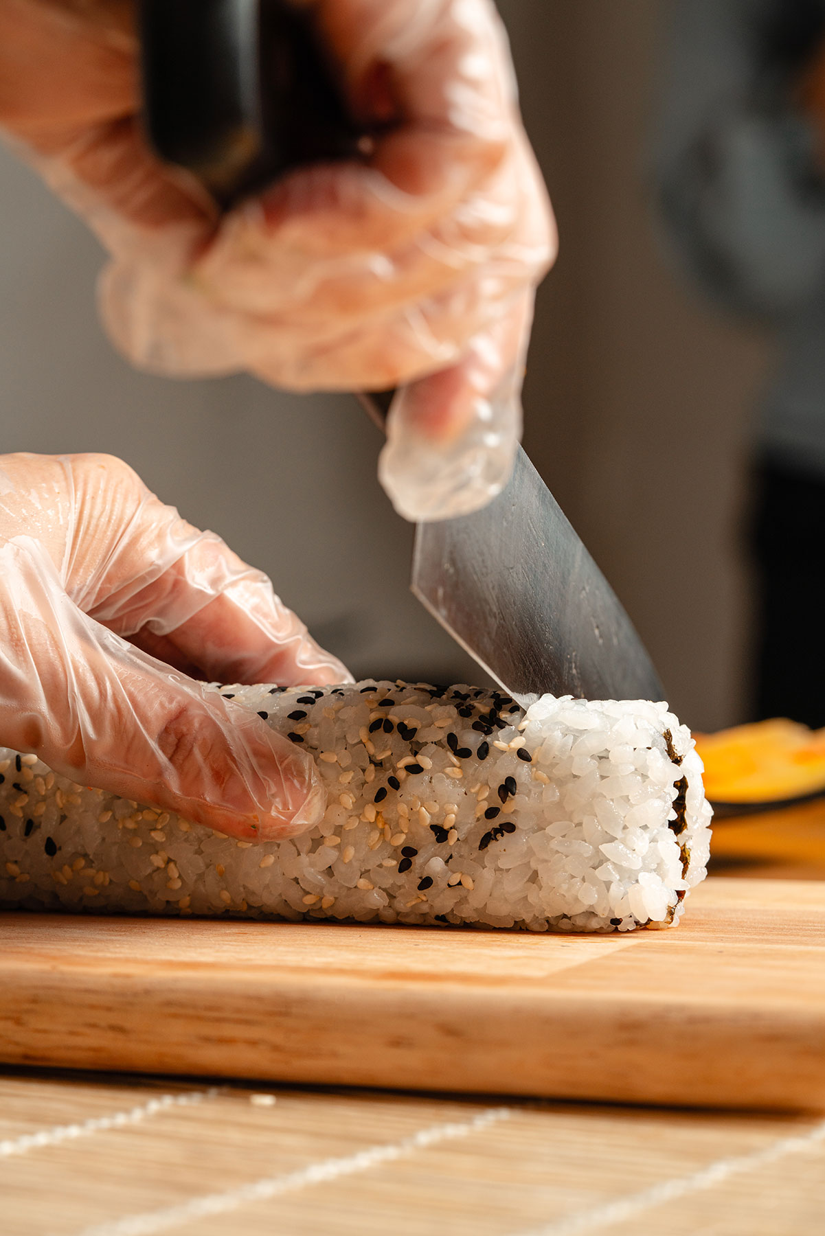 A chef's hands at work behind the TSURU counter.